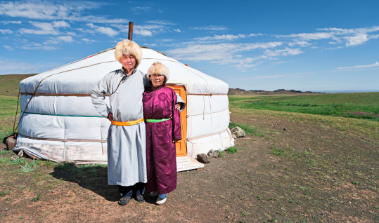 Mongolian couple in national clothing, ger (yurt) in the background.http://bem.2be.pl/IS/mongolia_380.jpg