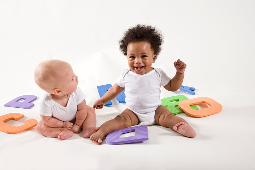 Multiracial babies learning ABC's, playing with letters having fun