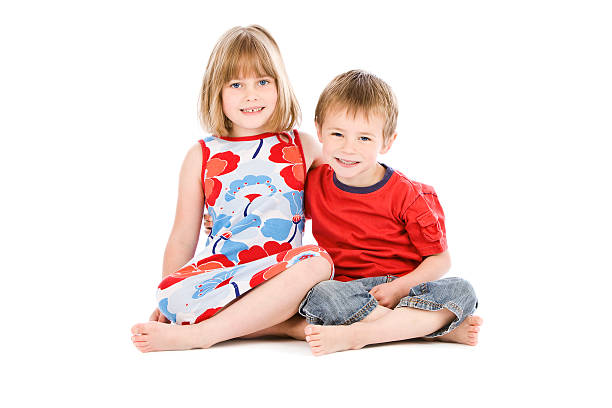 istock Young boy and girl sitting on white background 183045237