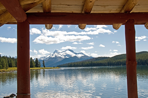 A view from the deck of a cabin located high in the Rocky Mountains on  tranquil Maligne calm lake.