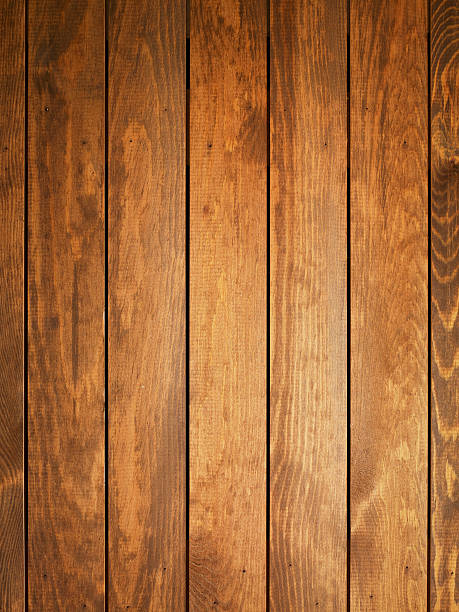 Overhead view of light brown wooden table A wood background with multiple planks placed close together.  The planks feature a variety of light and dark brown shades.  The darkest shades are on the corners, the lightest on the middle planks. oak wood material photos stock pictures, royalty-free photos & images