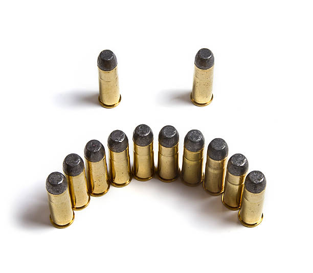 Nimbus Made Of Bullets Around Head Of Baby Doll On White Surface