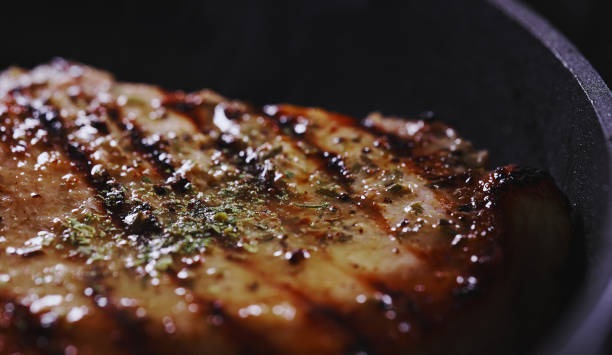 istock Seasoned tomahawk steak is cooked in a frying pan. 1830465026