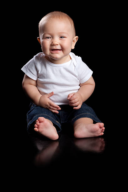 istock Happy Baby Sitting on Black Background 183046526