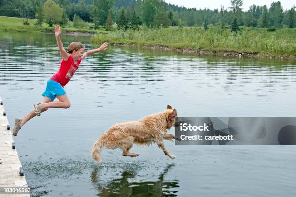 Girl Swimming With Her Dog Stock Photo - Download Image Now - Dog, Jumping, Lake