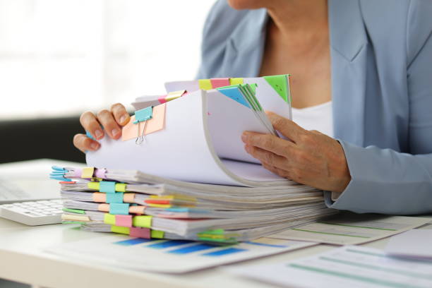 istock Senior businesswoman is stressed from doing too much paperwork. 1830469546