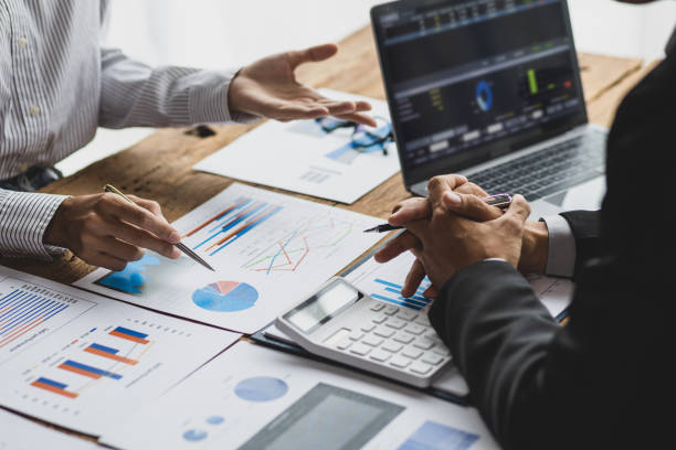istock Business advisory meeting discussing analyzing company growth using business reports and financial charts. Brainstorming, analyzing strategies and planning investments. 1830470133