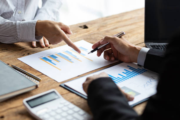 istock Business advisory meeting discussing analyzing company growth using business reports and financial charts. Brainstorming, analyzing strategies and planning investments. 1830470137