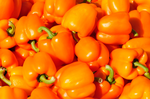 Close-up image of red, yellow and green peppers.