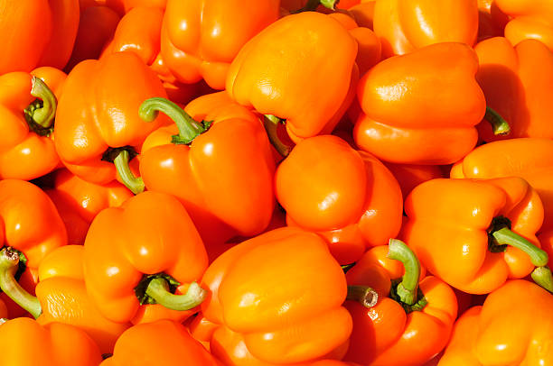 Orange peppers at a street market stock photo