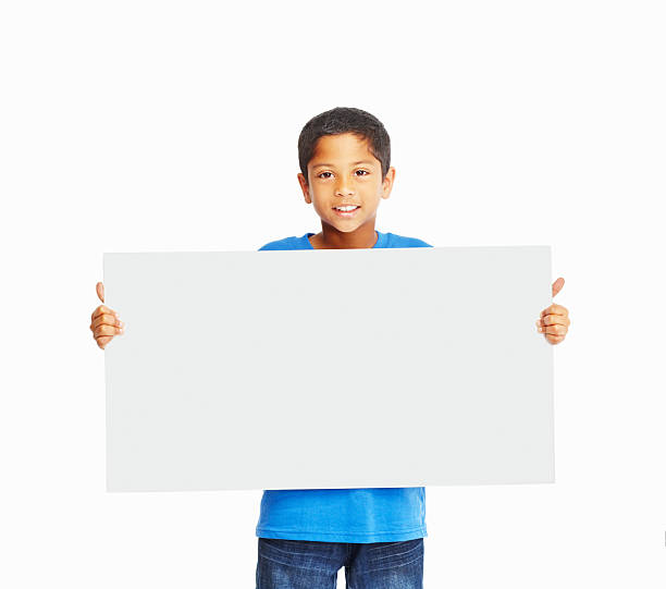 istock An adorable boy holding banner isolated on white background 183047574