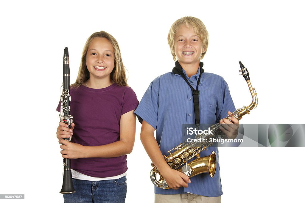 Young Musicians on a White Background "Two young musicians, ages eleven and fourteen holding their clarinet and Saxophone smiling." Child Stock Photo