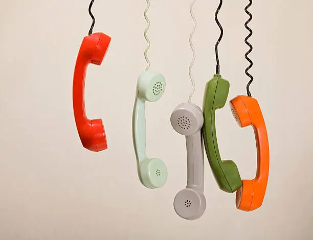 "five colorful handset hanging in a row,"