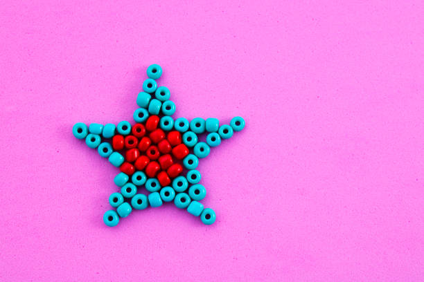 Star formed with red and greenish blue beads