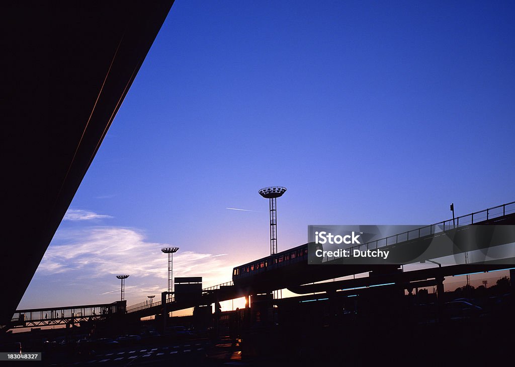 People mover at Orly airport in Paris, France "Sunset at Orly Airport with elevated people mover and in the back a covered walkway with people. Silhouette-image, high-end scan of 6x7cm transparency.View more related images in one of the following lightboxes:" Airport Stock Photo