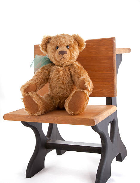 istock Teddy Bear Sitting at School Desk 183048344