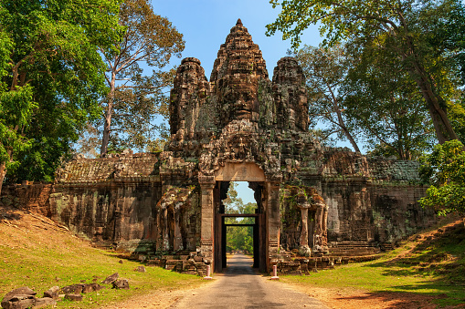 Victory Gate (Thvear Chey) to Angkor Thom (Nokor Thom, the Great City) in Cambodia. Ancient gate to old capital city of the Khmer Empire from the 12th century.