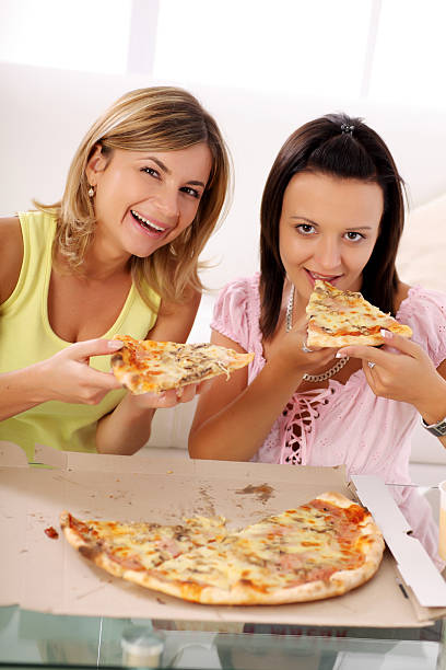 istock Two girls eating pizza . 183048979
