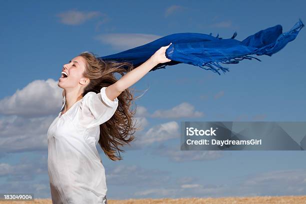 Carefree Young Woman Outdoors Shouting With Joy Into The Wind Stock Photo - Download Image Now