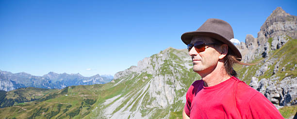 istock Hiker Looking at Panoramic View of the Swiss Mountains 183049239