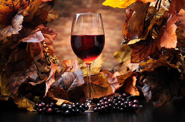 Red Wine with Autumn Decoration -  selective focus