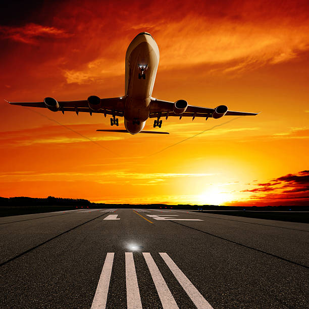 istock XL jet airplane landing at sunset 183049549