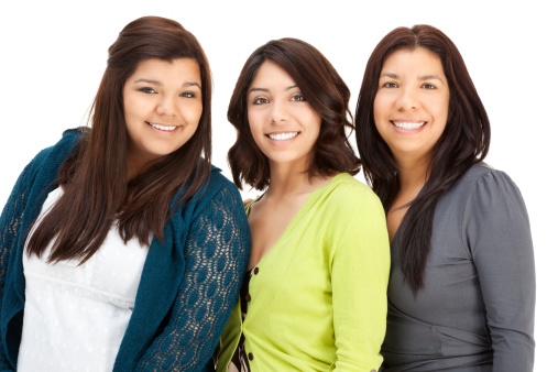 Portrait of a Hispanic mother with two daughters; isolated on white.