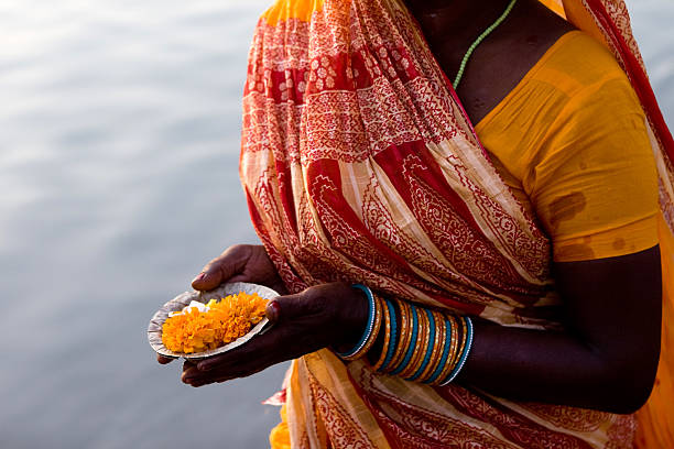 istock A woman holding out and offering Puja 183049706