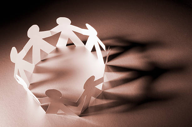 istock Chain of paper dolls in a circle showing community 183049730