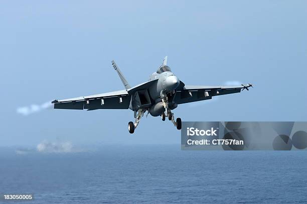 A Fighter Jet In The Air Over The Sea Stock Photo - Download Image Now - Navy, Fighter Plane, US Navy