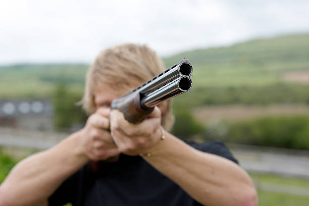 istock Handsome young man pointing shotgun 183050414