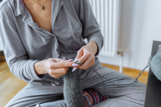 istock young woman knits wool product 1830510061