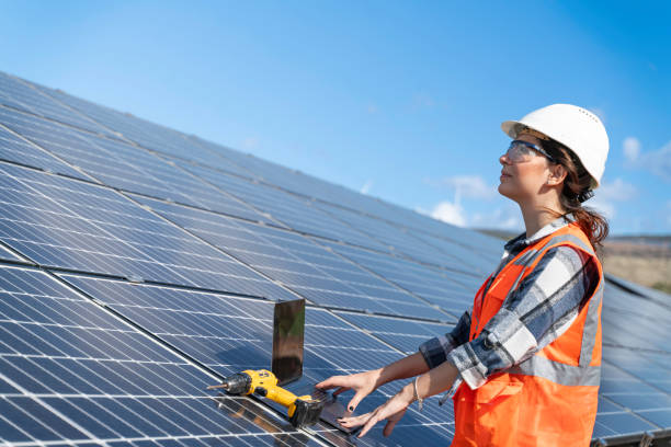 istock Young engineer inspect installation of solar panels installed check  with blueprint on the field, with recording inspection data on pc. 1830514474