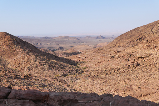Trekking tour through the area of Wadi Araba and Shkaret Mseid in Jordan. Through a lonely, impassable and barren landscape of rocks and mountains.