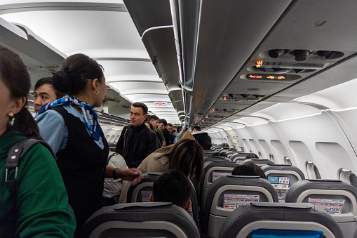 Moscow, Russia - September 29, 2022: Inside of old Airbus A-320 while people are boarding