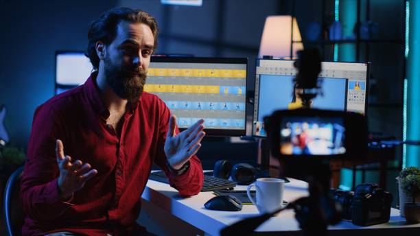 istock Photographer using professional camera to film content, discussing about image retouching software 1830523050
