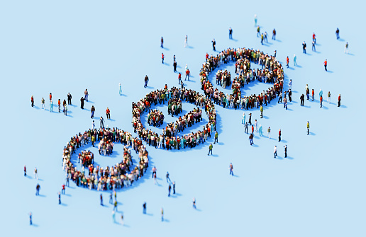 Human crowd forming smiley faces blue background. Horizontal composition with copy space.