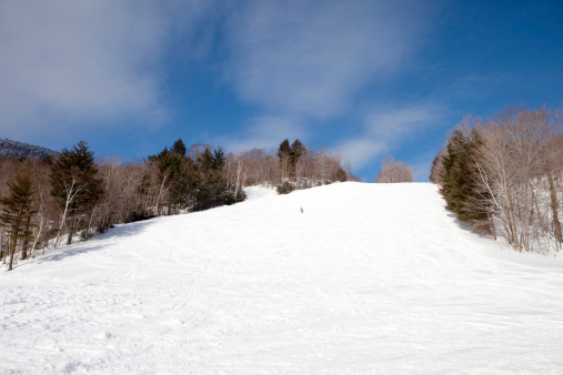 A solitary skier coming down a Vermont ski slope.Click to see more Winter images.