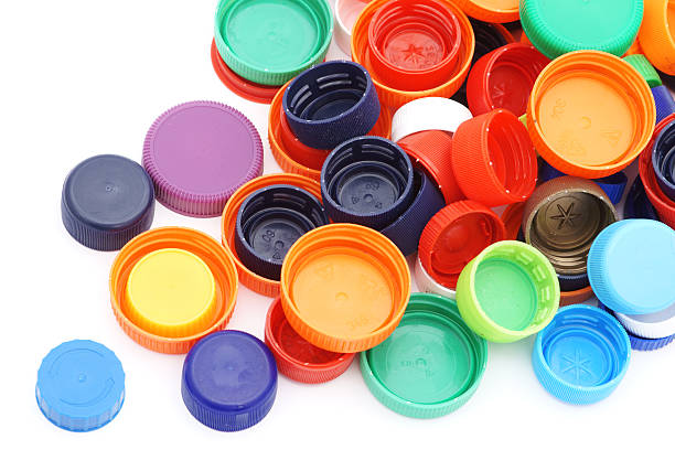 istock Scattered colorful plastic caps isolated in white 183053644