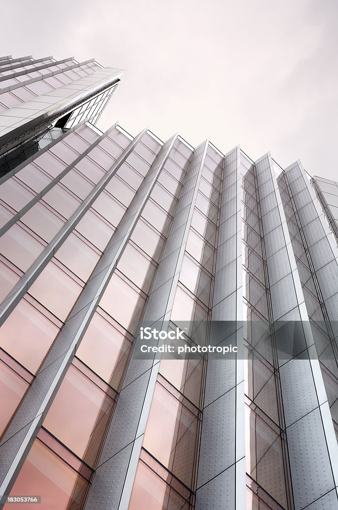 skyscraper abstract a view of the top of a skyscraper in the City of London taken with a long lens. Composed at an angle to create an interesting abstract image. The colour of the metalised glass has been accentuated with a polariser filter and a graduated warm up filter has been used to warm the cloudy sky. Looking for exterior views of Luxury Homes and Buildings... then please see my other images by clicking on the lightbox Link below...A>A Architecture Stock Photo