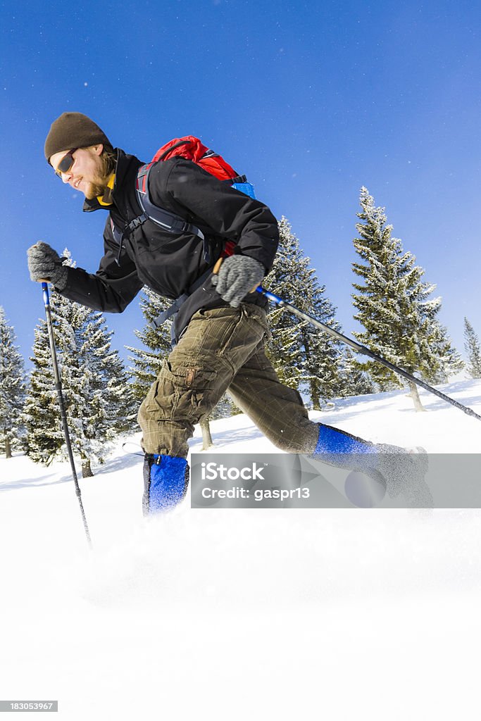 winter hiking man running on a fresh powder snow through a snowcapped forestCHECK OTHER SIMILAR IMAGES IN MY PORTFOLIO.... Active Lifestyle Stock Photo