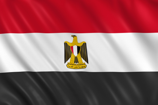 National flag of Egypt waving in the wind on a clear day. Horizontal red, white and black bands. Egyptian eagle emblem centered in white band. 3d illustration render. Fluttering fabric