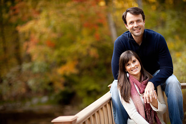 istock Happy Couple Sitting Together Outside During Autumn 183054372