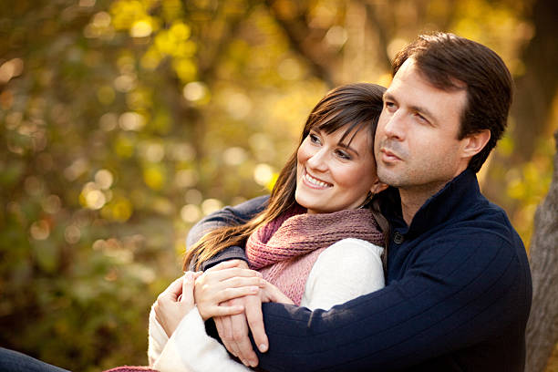 Happy Couple Sitting Together Outside During Autumn