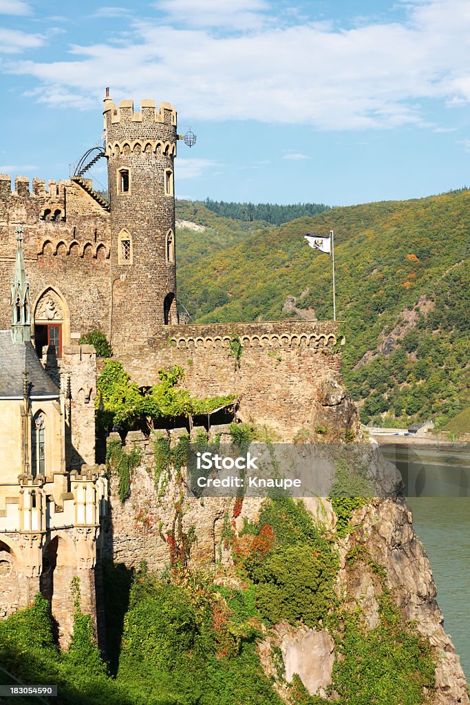 Close-up of magnificent Rheinstein Castle located in hill Rheinstein castle in the hills above river Rhine. Flag: flag of kingdom of Prussia (1892 - 1918). Castle Stock Photo