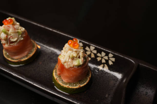 istock Sushi rolls with salmon, lime, red caviar, close-up 1830548836
