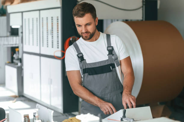 istock Smart engineer. Handsome man is working at the factory of creating eco boxes 1830551166