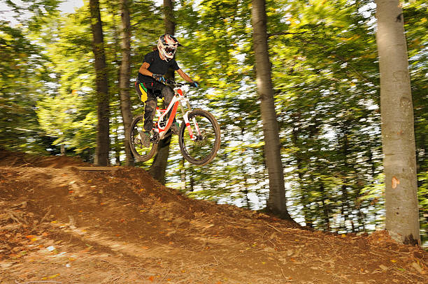 istock Mountain biker at downhill jump 183055361