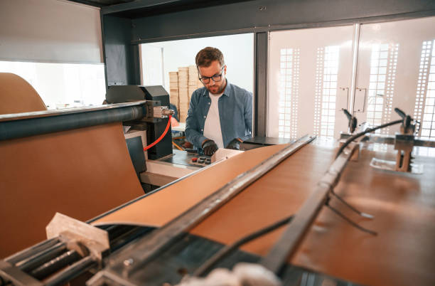 istock Handsome man is working at the factory of creating eco boxes 1830553892