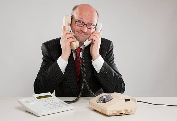 istock Businessman with two phones 183055511